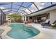 Inviting pool with a built-in spa, a pizza oven, lounge chairs, and an expansive patio area at 11410 57Th E St, Parrish, FL 34219