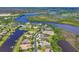 An aerial view captures luxurious waterfront homes with private docks along a tranquil waterway at 11807 Rive Isle Run, Parrish, FL 34219