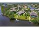 Expansive property featuring a private pool, lush greenery, a dock, and stunning waterfront views from an aerial perspective at 11807 Rive Isle Run, Parrish, FL 34219