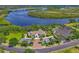 Beautiful aerial shot of building with elegant landscaping, ample parking, and scenic river views in a prime location at 11807 Rive Isle Run, Parrish, FL 34219