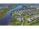 A beautiful community of waterfront homes with private docks and lush landscaping is shown from above at 11807 Rive Isle Run, Parrish, FL 34219