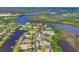 An aerial view captures luxurious waterfront homes with private docks along a tranquil waterway at 11807 Rive Isle Run, Parrish, FL 34219