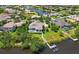 Stunning aerial view of waterfront home with private dock, pool, and lush landscaping in a desirable neighborhood at 11807 Rive Isle Run, Parrish, FL 34219