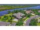 Gorgeous aerial view of a luxury home with well-manicured lawn, lush trees, and serene river access in a tranquil setting at 11807 Rive Isle Run, Parrish, FL 34219