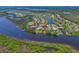 An aerial view of a waterfront community with homes, private docks, lush greenery, and waterways at 11807 Rive Isle Run, Parrish, FL 34219