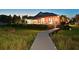 Picturesque backyard featuring lush greenery, patio, and charming lighted boardwalk leading to the water at 11807 Rive Isle Run, Parrish, FL 34219