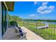 Spacious waterfront backyard with a paver patio, comfortable chairs and dock at 11807 Rive Isle Run, Parrish, FL 34219