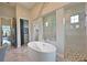 Elegant bathroom featuring a soaking tub, walk-in shower, and stylish fixtures at 11807 Rive Isle Run, Parrish, FL 34219