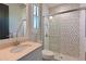 Well-lit bathroom features a tiled shower with glass door and a marble countertop at 11807 Rive Isle Run, Parrish, FL 34219