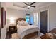 Cozy bedroom featuring a decorative ceiling, an ensuite bathroom, and a view to the outdoors at 11807 Rive Isle Run, Parrish, FL 34219