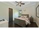 Comfortable bedroom with hardwood floors, ceiling fan, and a rustic wood bed frame at 11807 Rive Isle Run, Parrish, FL 34219