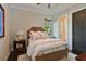 Cozy bedroom featuring soft lighting, a comfy bed, and an ensuite bathroom at 11807 Rive Isle Run, Parrish, FL 34219