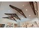 High ceilings with wooden beam details and recessed lighting above the open kitchen area at 11807 Rive Isle Run, Parrish, FL 34219
