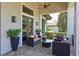 Inviting covered patio with stylish outdoor furniture, creating a perfect space for relaxation and entertainment at 11807 Rive Isle Run, Parrish, FL 34219