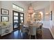 Elegant dining room featuring a round table, stylish chairs, modern lighting, and rich wood flooring at 11807 Rive Isle Run, Parrish, FL 34219