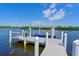 View of the boat dock on the water with a boat lift at 11807 Rive Isle Run, Parrish, FL 34219