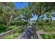 Scenic wooden dock extending over the water, surrounded by lush greenery and offering stunning views at 11807 Rive Isle Run, Parrish, FL 34219