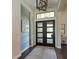 Elegant entryway with a modern chandelier and a stylish front door at 11807 Rive Isle Run, Parrish, FL 34219