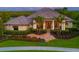 Stunning home featuring lush landscaping, paver walkway, and decorative stone accents at 11807 Rive Isle Run, Parrish, FL 34219