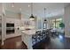Spacious kitchen with a large central island, stainless steel appliances, and adjacent dining area at 11807 Rive Isle Run, Parrish, FL 34219