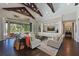 Bright living room with wood beams, hardwood floors, and sliders to the outside patio and pool area at 11807 Rive Isle Run, Parrish, FL 34219