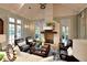 Elegant living room with a cozy fireplace, comfortable seating, and stylish décor, creating a welcoming ambiance at 11807 Rive Isle Run, Parrish, FL 34219