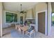 Outdoor kitchen with stainless steel appliances, grill, large dining table, and ceiling fan at 11807 Rive Isle Run, Parrish, FL 34219