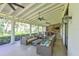 Expansive outdoor living space featuring comfortable seating, an outdoor kitchen, and ceiling fans for year-round comfort at 11807 Rive Isle Run, Parrish, FL 34219