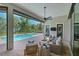 Outdoor patio with comfortable seating, a ceiling fan, and a beautiful pool with a scenic water view at 11807 Rive Isle Run, Parrish, FL 34219