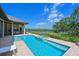 Backyard pool and spa with brick patio and serene views of the lake beyond the fenced yard at 11807 Rive Isle Run, Parrish, FL 34219