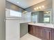 Modern bathroom with double vanity, shower with glass surround, and bright lighting at 11811 Fennemore Way, Parrish, FL 34219