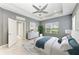 Charming bedroom features a ceiling fan, tray ceiling, a neutral color palette, and ample natural light at 11811 Fennemore Way, Parrish, FL 34219