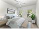 Bright bedroom featuring two windows with natural light, ceiling fan, and neutral decor at 11811 Fennemore Way, Parrish, FL 34219