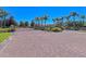Elegant community entrance with brick-paved road, iron gates, and well-maintained landscaping at 11811 Fennemore Way, Parrish, FL 34219
