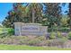Welcome to Forest Creek, sign featuring stone accents and manicured landscaping, creating an inviting entry at 11811 Fennemore Way, Parrish, FL 34219