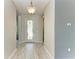 Bright and airy foyer featuring hardwood flooring and a glass-paneled front door at 11811 Fennemore Way, Parrish, FL 34219