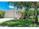 Charming single-story home with a well-maintained lawn, mature trees, and an attached two-car garage at 11811 Fennemore Way, Parrish, FL 34219