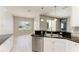 This kitchen offers a breakfast bar, stainless steel appliances, and sliding glass doors at 11811 Fennemore Way, Parrish, FL 34219