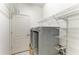 Convenient laundry room with modern washer and dryer and built-in wire shelving at 11811 Fennemore Way, Parrish, FL 34219