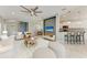 Spacious living room showcasing an open layout, stylish furnishings, and seamless flow to kitchen and dining area at 11811 Fennemore Way, Parrish, FL 34219