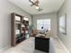 Spacious office featuring ample shelving, a modern desk, and a comfortable executive chair at 11811 Fennemore Way, Parrish, FL 34219