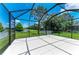 Screened-in patio offers views of the lush lawn and tranquil pond at 11811 Fennemore Way, Parrish, FL 34219