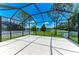 Screened-in patio overlooking a serene pond, providing a peaceful outdoor space at 11811 Fennemore Way, Parrish, FL 34219