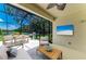 Relaxing screened patio with outdoor dining area, comfortable seating, and TV at 11811 Fennemore Way, Parrish, FL 34219