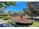Community playground area with swings, climbing structure, and covered seating, ideal for families at 11811 Fennemore Way, Parrish, FL 34219