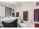 Bathroom featuring a white sink, large mirror, vanity, toilet, and towels on chrome bars at 1355 Rock Dove Ct # 1-2, Punta Gorda, FL 33950