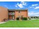Two-story condo featuring a well-maintained lawn, vibrant landscaping and a balcony overlooking the grounds at 1355 Rock Dove Ct # 1-2, Punta Gorda, FL 33950