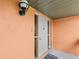 Close-up of a home's front door with side lights, and showing the entry awning at 1355 Rock Dove Ct # 1-2, Punta Gorda, FL 33950