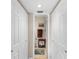 Hallway leading to a bathroom with a towel rack and tiled floor at 1355 Rock Dove Ct # 1-2, Punta Gorda, FL 33950