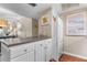 Well-lit kitchen with white cabinets, a breakfast bar, and views into the adjacent living area at 1355 Rock Dove Ct # 1-2, Punta Gorda, FL 33950